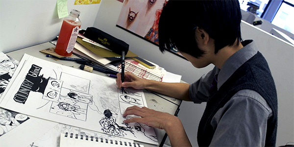 student working on graphic novel