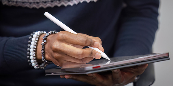 person drawing on tablet